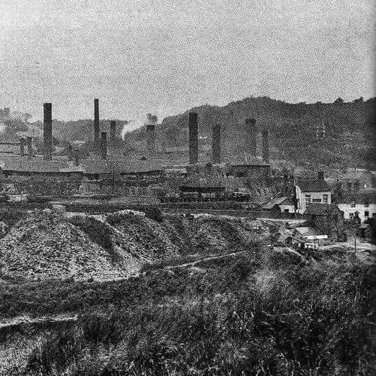 Industrial Jackfield: chimneys, spoil mounds and railway sidings around the Coalford brickworks, with the pub and cottages on the right.