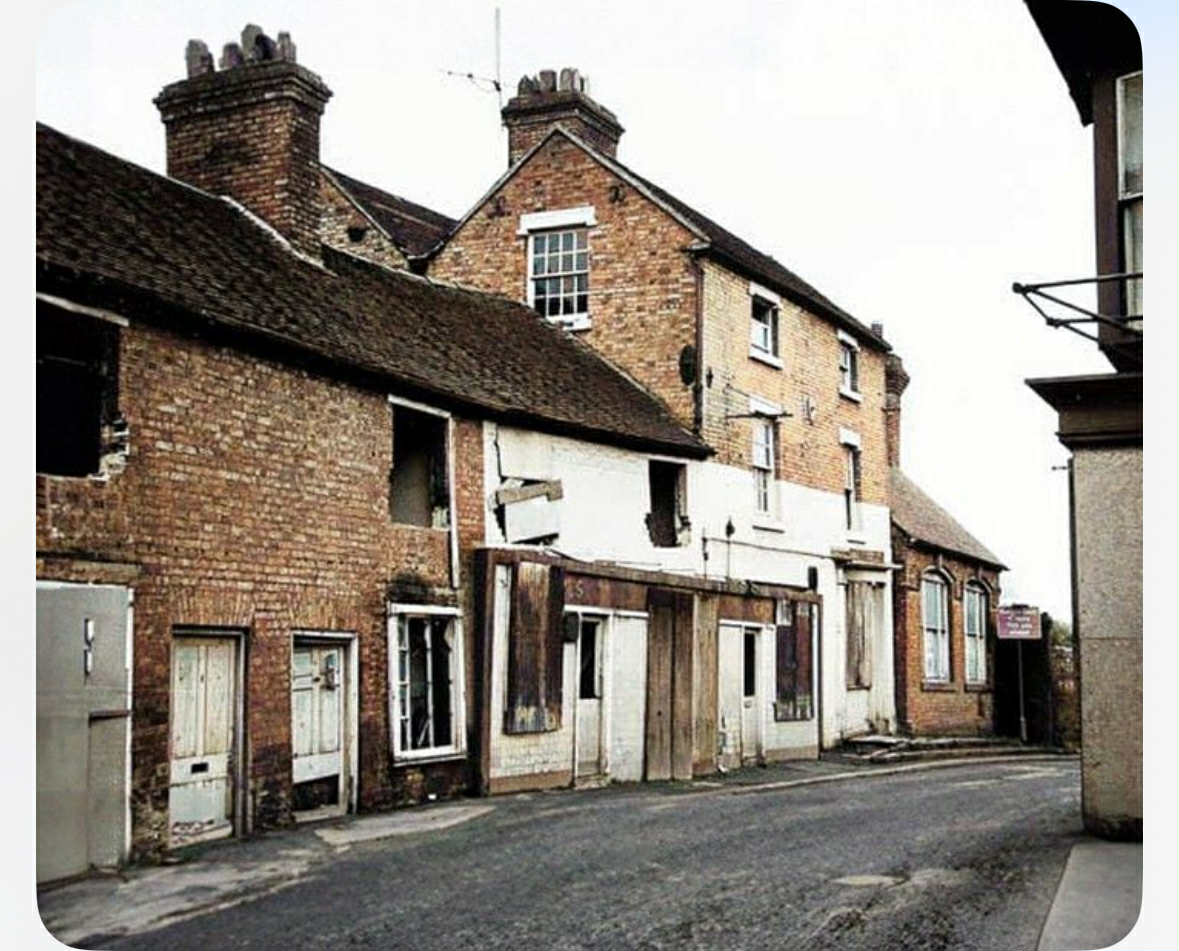 Boarded shopfronts and empty windows on the condemned row